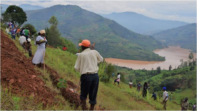 People digging filtration ditches on a steep mountain